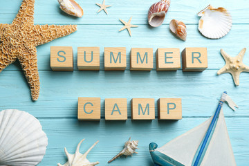 Wall Mural - Flat lay composition with phrase SUMMER CAMP made of cubes on light blue wooden background