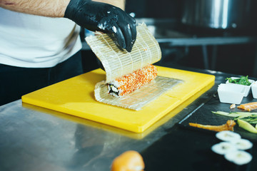 Wall Mural - Photo of Chef preparing rolls in kitchen, fresh and tasty japan food