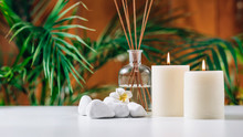 Aromatherapy Concept. Aromatic White Candles And Essential Oil Reed Diffusers