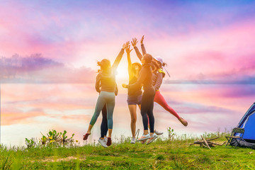 Group of five friends jumping and tapping hands for teamwork success. Teamwork concept..