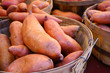 © eqroy - Basket of orange sweet potatoes at a farmers market