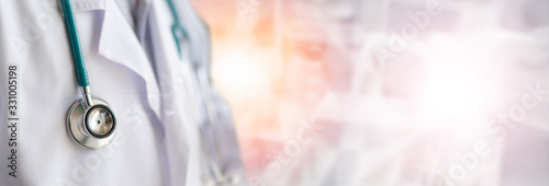 Fotomural Medical doctor or physician in white gown uniform with stethoscope in hospital o