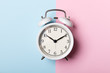 © Ivan Kmit - White vintage alarm clock on blue and pink background. Time concept