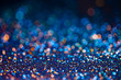 Festive twinkle glitters background, abstract sparkle backdrop with circles,modern design overlay with sparkling glimmers. Black, blue and golden backdrop glittering sparks with blur effect