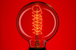 Retro lamp on a red background. The concept of electricity
