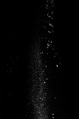  Started splash of white flour powder on black background