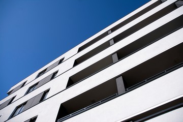 Modern apartment buildings on a sunny day with a blue sky. Facade of a modern apartment building