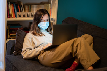 A white girl is working from home during Coronavirus or Covid-19 quarantine, coronavirus covid 19 infected patient in coronavirus covid 19 quarantine room using computer