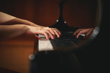 A Woman Playing The Piano