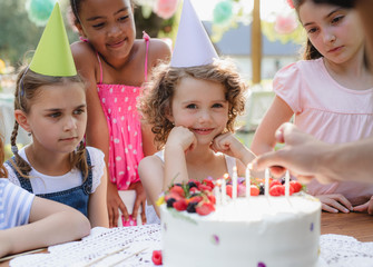 Kids birthday party outdoors in garden in summer, celebration concept.