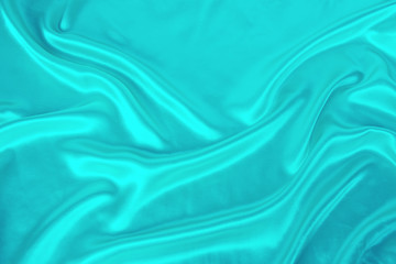 Wall Mural - soft folds on delicate turquoise shining silk, luxury concept, background for the designer, horizontal, close-up, copy space