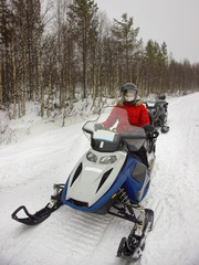 Poster - Woman managing snow mobile in Ruka of Lapland