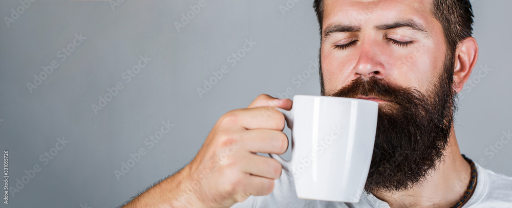 Portrait male. Closeup tea. Good morning, man holding a cup tea. Morning concept. Handsome bearded male holds cup of coffee, tea. Smiling hipster man with cup of fresh coffee - obrazy, fototapety, plakaty 