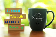 Hello Monday. Inspirational Quote - Dream Big. Set Goals. Take Action. Succeed. With Colorful Positive Motivational Words On Wooden Blocks And Morning Cup Of Coffee Closeup.