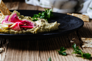 Wall Mural - Green hummus with pickled watermelon radishes