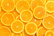 Leinwandbild Motiv Full frame of fresh orange fruit slices pattern background, close up, high angle view