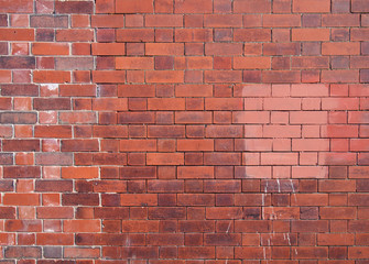  an old repaired patched exterior wall made of red bricks