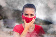 Woman suffocates in burning smoke, covers her nose, her face a mask from smog. A woman runs away from the fire, flames in the forest. Ecological catastrophy. SOS sign for help, emotion anxiety. Smog