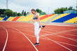 © BullRun - Sporty woman stretching at stadium