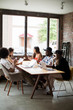 © Cavan for Adobe - Male and female coworkers using laptop computers while sitting at table in creative workplace