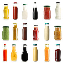 Different Tasty Sauces In Bottles And Jars On White Background