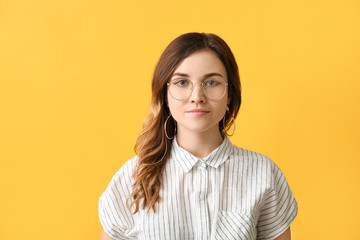 Stylish woman with stylish eyeglasses on color background