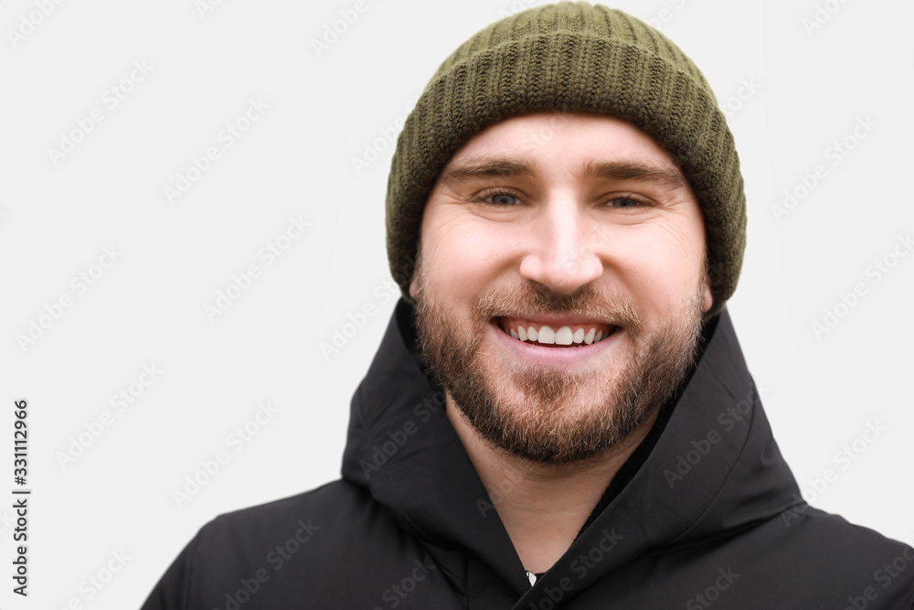 Happy smiling young man on light background