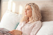 © Pixel-Shot - Morning of beautiful young woman reading newspaper in bed