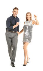 Wall Mural - Happy dancing young couple on white background