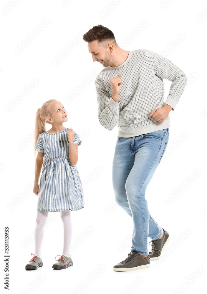 Man and his little daughter dancing against white background