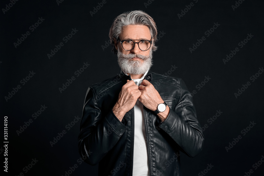 Stylish elderly man on dark background