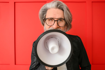 Sticker - Stylish elderly man with megaphone on color background