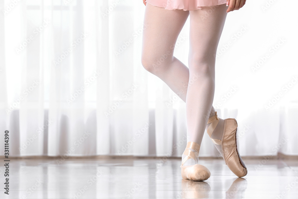 Legs of beautiful young ballerina in dance studio