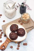 Chocolate Cookies With Choco Drops On White Plate, And Glass Of Milk
