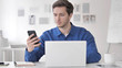 © stockbakers - Man Using Smartphone and Laptop for Work