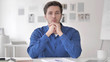 © stockbakers - Confident Casual Adult Man Sitting at Workplace