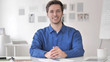 © stockbakers - Successful Smiling Casual Adult Man Sitting at Workplace