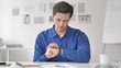 © stockbakers - Young Man Relaxing on Couch and Using Smartwatch Applications