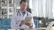 © stockbakers - Senior Doctor Using Tablet for Online information