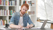 © stockbakers - Young Casual Redhead Man Writing Letter