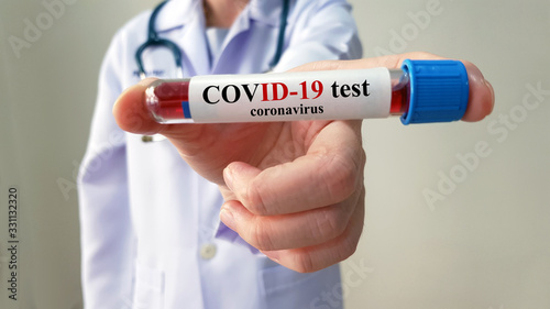 Doctor show laboratory COVID-19 test for diagnosis new Corona virus infection(novel corona virus disease 2019 or COVID)from Wuhan, ready for screening and treatment. Pandemic infectious concept