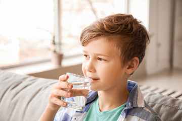 Sticker - Cute little boy drinking water at home