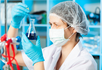 Wall Mural - scientist holds and examine samples in a laboratory