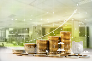 Financial and banking / Finance and business concept:  Arrange rows of increasing coins and graph growth business investment on workplace background. depicts investing money for earning growth.