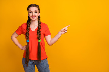 Canvas Print - Photo of pretty excited lady direct finger side empty space demonstrating novelty product low prices wear casual red t-shirt jeans isolated bright yellow color background