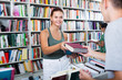 © JackF - Portrait of girl getting help with book choice