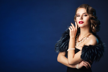 Wall Mural - woman retro beauty portrait, fashion model old fashioned hairstyle and make up, studio shot on blue 