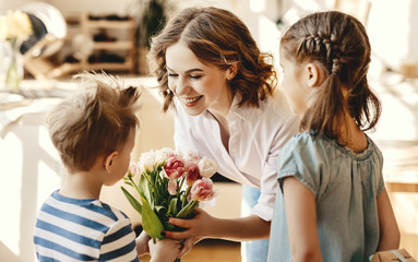 Wall Mural - little children congratulating mother in kitchen.