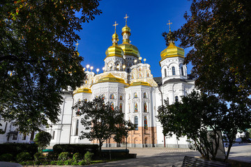 View of the temples of Kiev-Pechersk Lavra on a beautiful sunny autumn day. Gold domes, orthodox crosses. UNESCO World Heritage Site