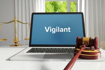 Vigilant – Law, Judgment, Web. Laptop in the office with term on the screen. Hammer, Libra, Lawyer.